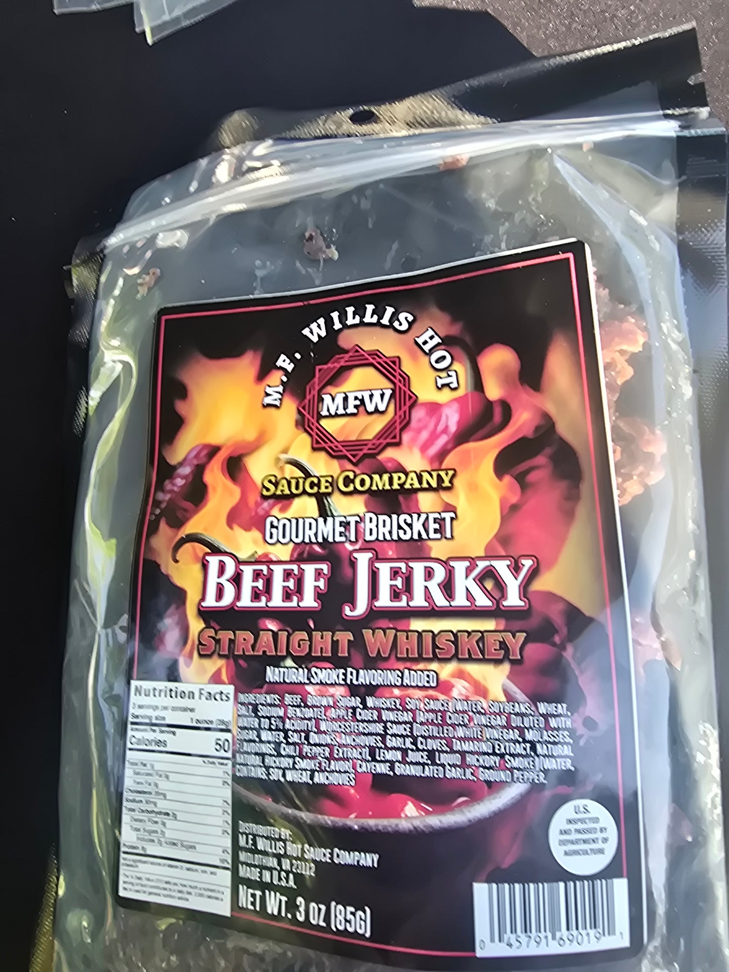 Straight Whiskey Beef Jerky in a gourmet package with bold branding and rich flavors.